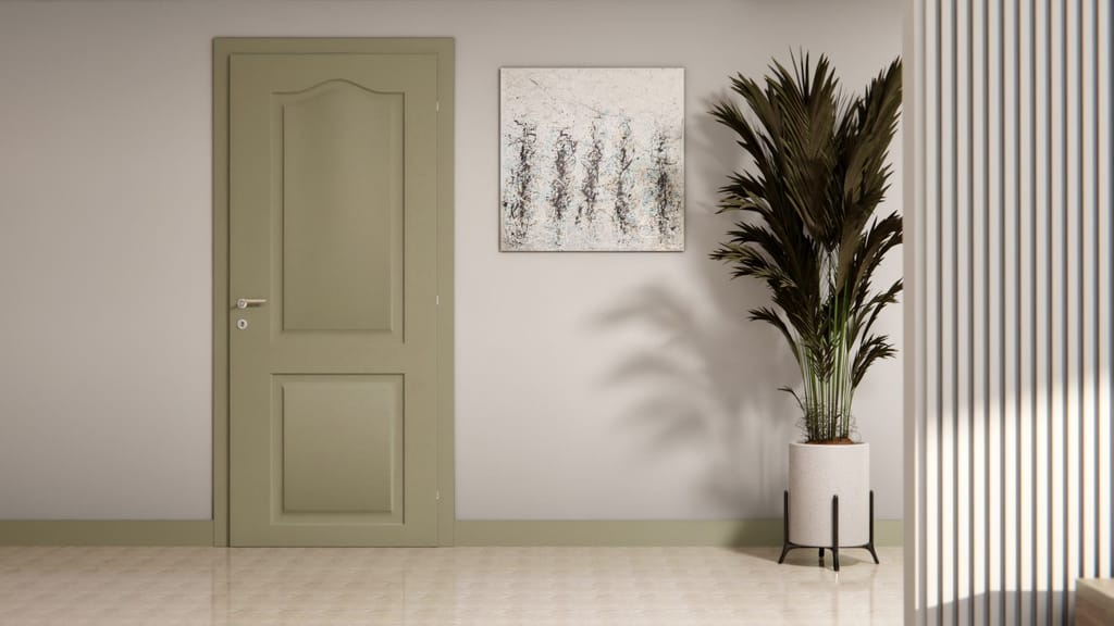 Porte intérieure à panneaux moulurés habillée d'un vert olive mat sur mur clair, avec plante et tableau